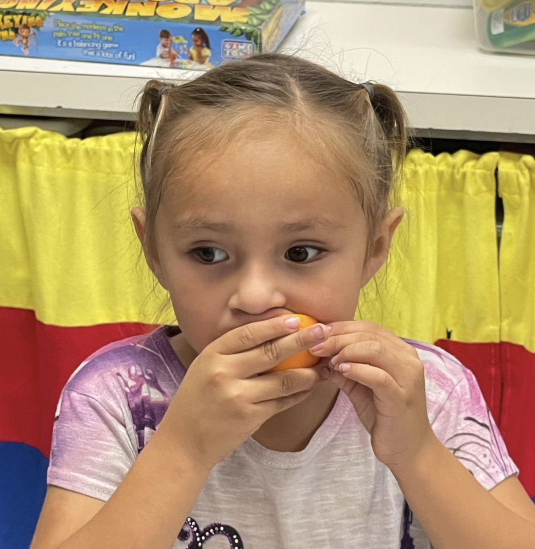 Girl eating fruit